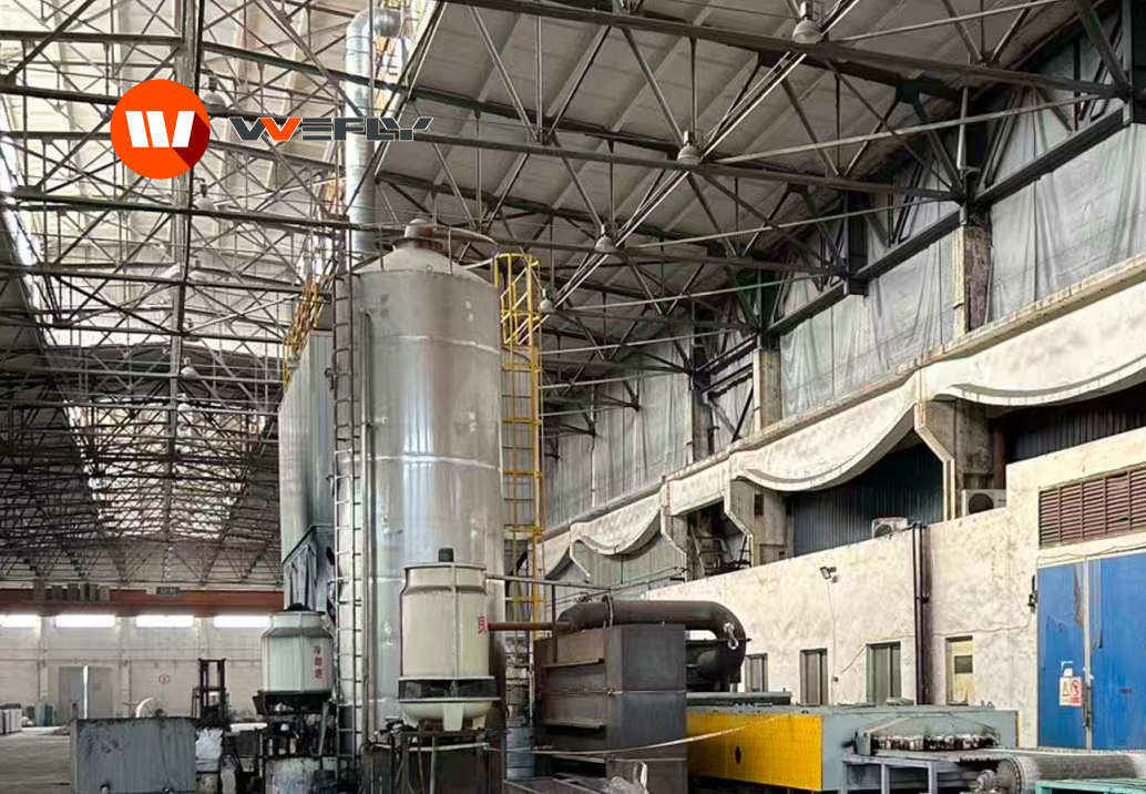 Pyrolysis off-gas treatment system on site: spray tower, gas ducting, induced draft fan installed in a recycling plant workshop.